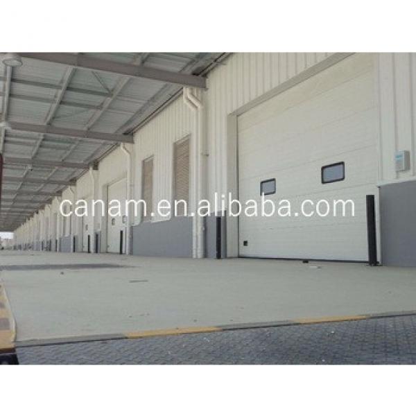 Sectional Industrial Door -- Overhead; High Lifting, Vertical Uplifting Available #1 image